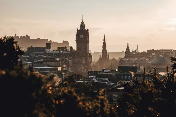 Edinburgh skyline at sunset with the Balmoral clock tower and Scott Monument