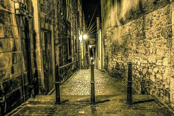 Cobbled close lit by lamps at night