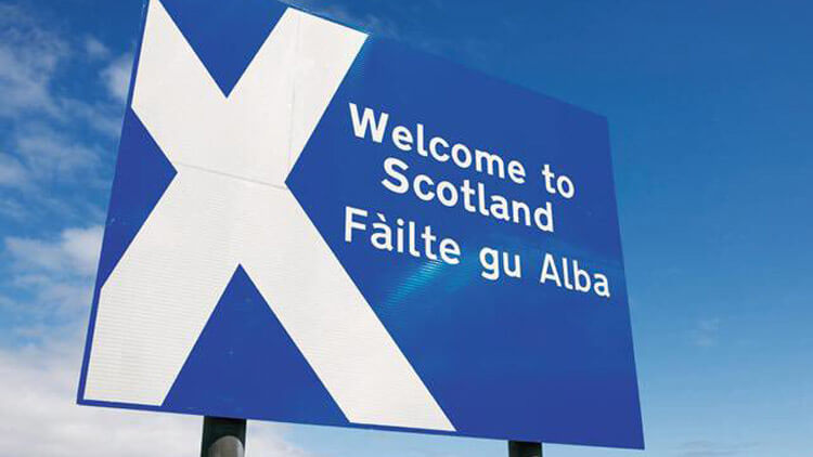 Cartel de bienvenida a Escocia en varios idiomas oficiales