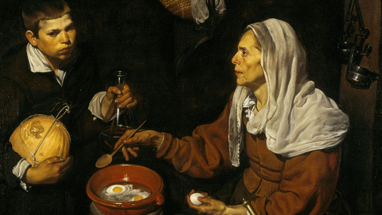 Old woman cooking eggs